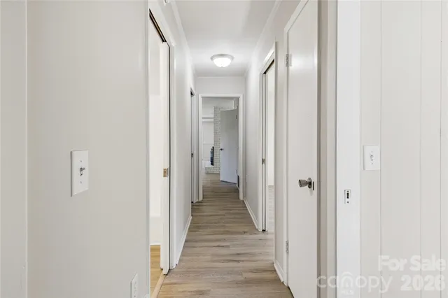 a view of a hallway with wooden floor