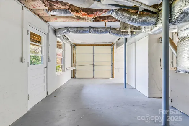 a view of a room with a window and brick wall