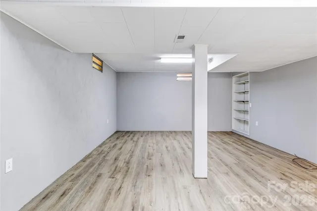a view of wooden floor and windows in a room