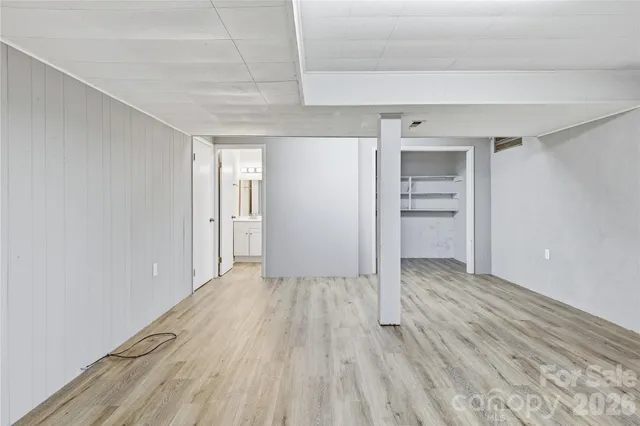 a view of an empty room and closet area