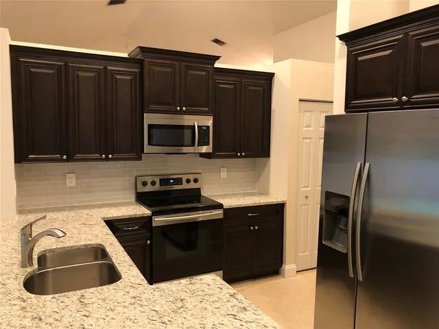 a kitchen with a refrigerator sink and microwave