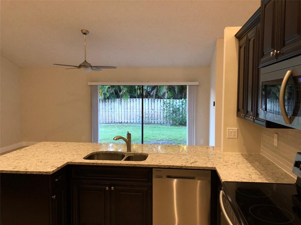 9488 Majestic Way Boynton Beach, FL 33437 - Photo 5 of 15 a kitchen with a sink and a window