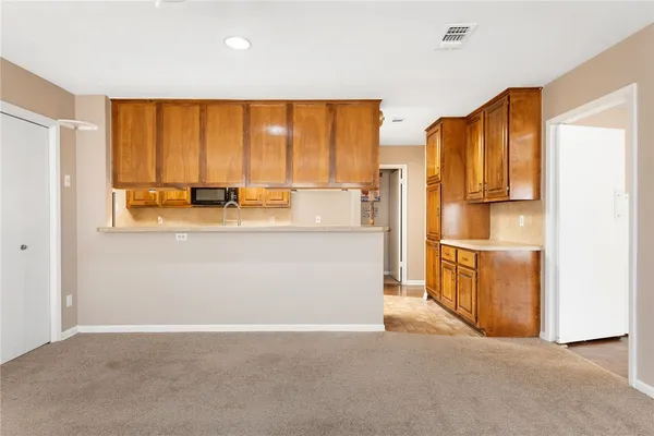a kitchen with stainless steel appliances granite countertop a sink and cabinets