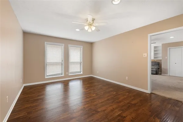 a big room with chandelier and windows
