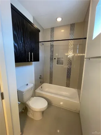 an empty room with wooden floor and ceiling fan