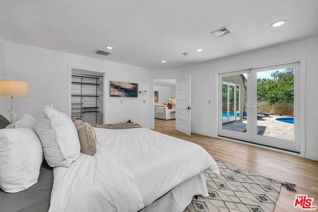 a bed room with a bed and a large window