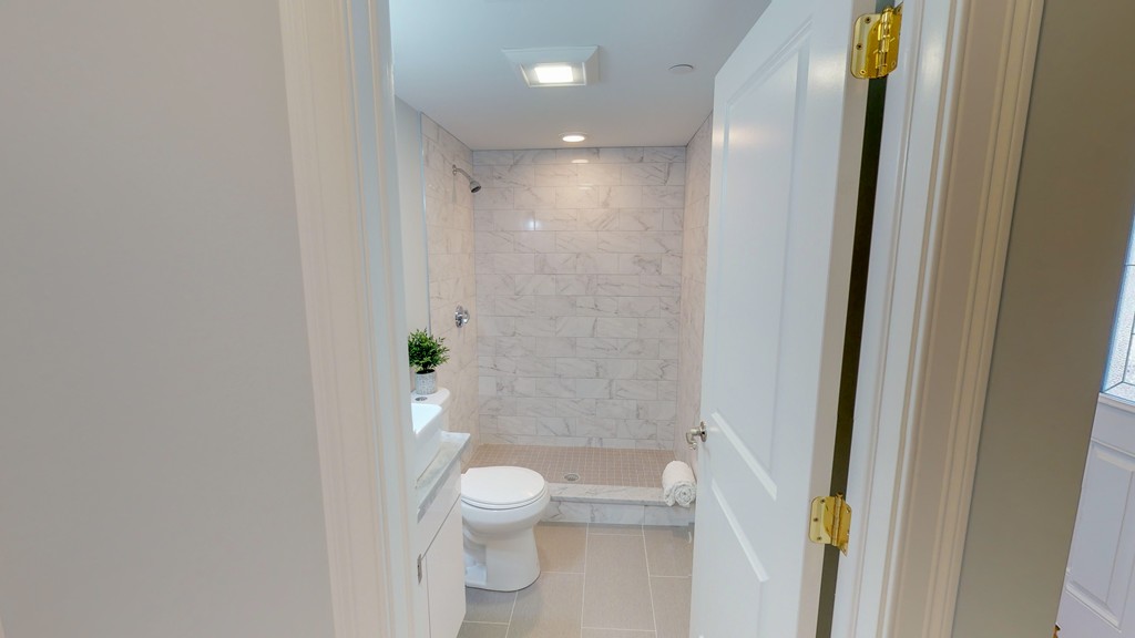 179 Rindge Avenue, Unit 1 Cambridge, MA 02140 - Photo 3 of 9 a bathroom with a toilet and a shower