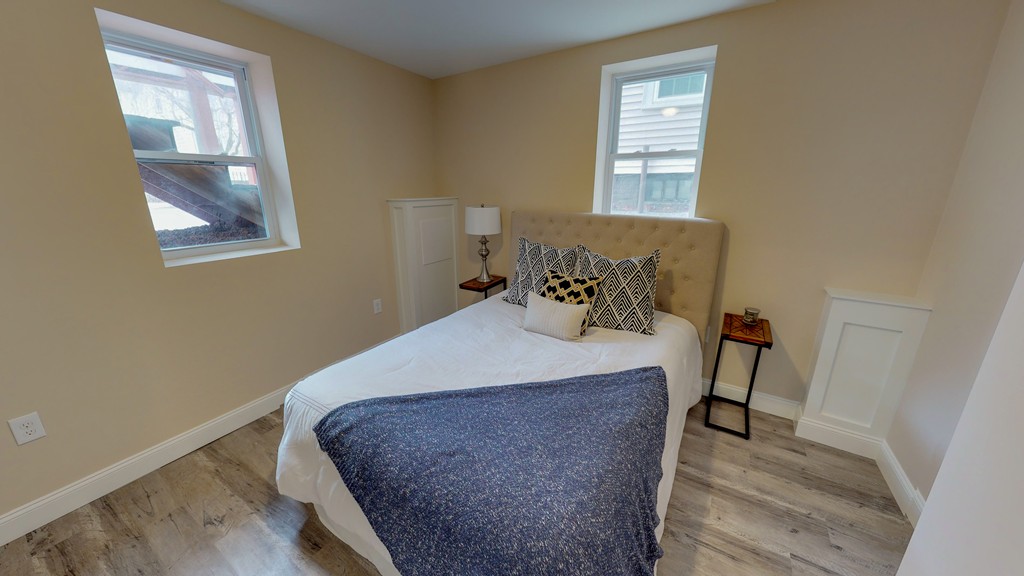 179 Rindge Avenue, Unit 1 Cambridge, MA 02140 - Photo 5 of 9 a bed sitting in a bedroom next to a window