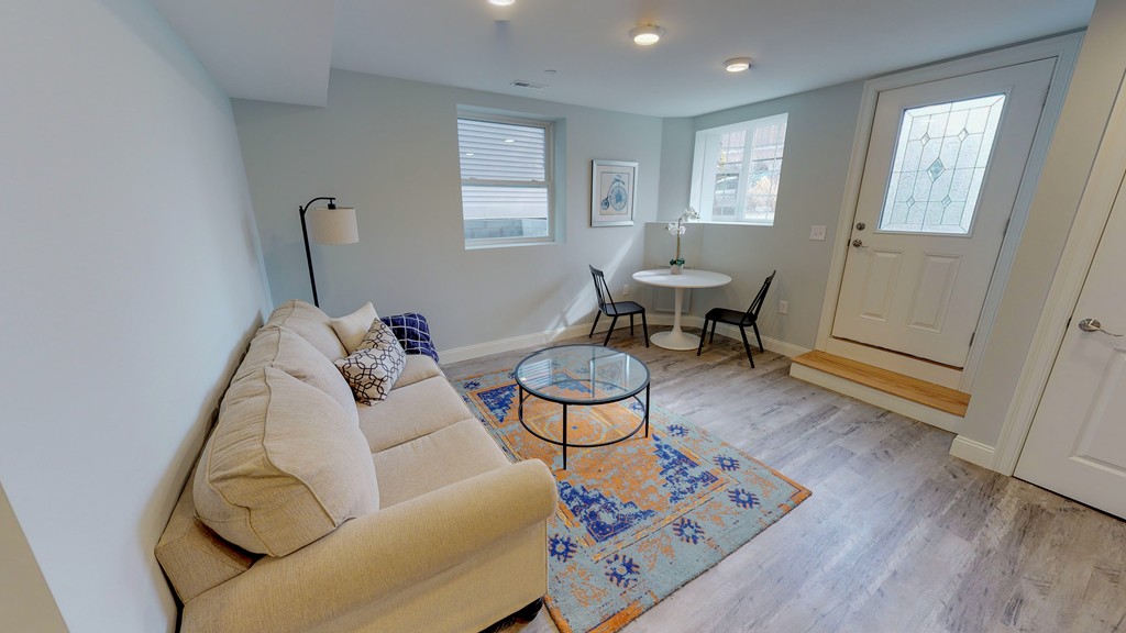 179 Rindge Avenue, Unit 1 Cambridge, MA 02140 - Photo 6 of 9 a living room with furniture a window and a dining table