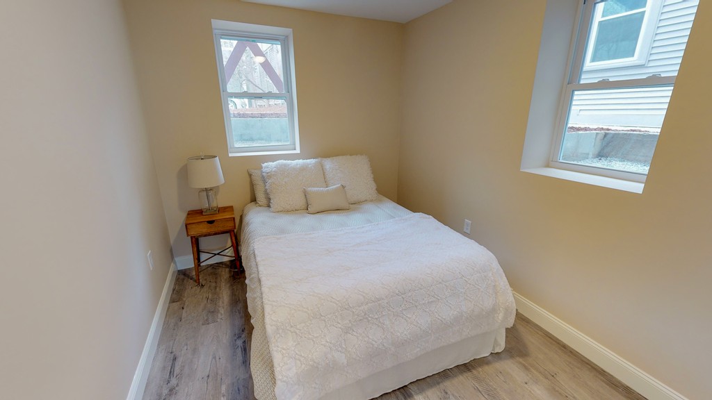 179 Rindge Avenue, Unit 1 Cambridge, MA 02140 - Photo 7 of 9 a bedroom with a bed and a window