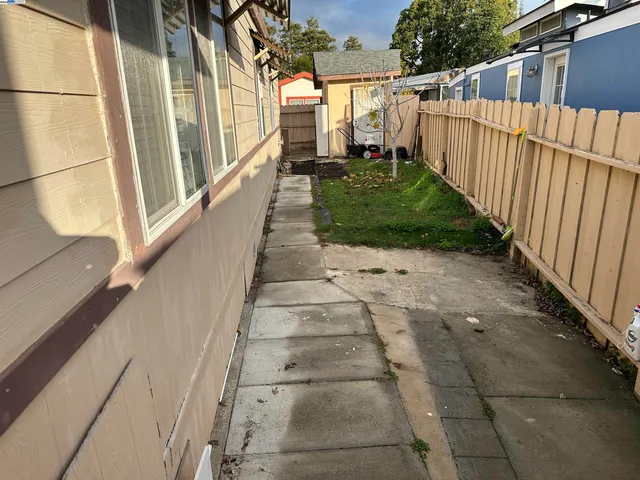 a view of a pathway of a house with a yard