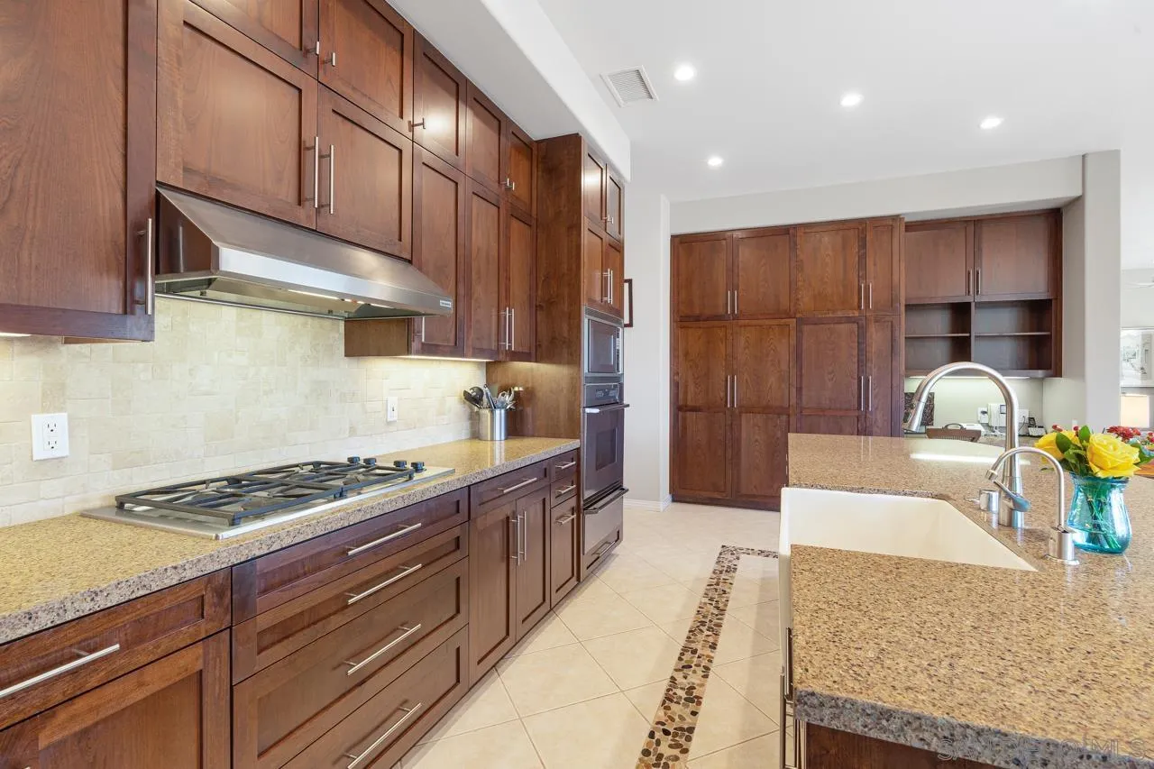 17065 Butterfield Trail Poway, CA 92064 - Photo 21 of 71 a kitchen with stainless steel appliances granite countertop a stove a sink and a refrigerator