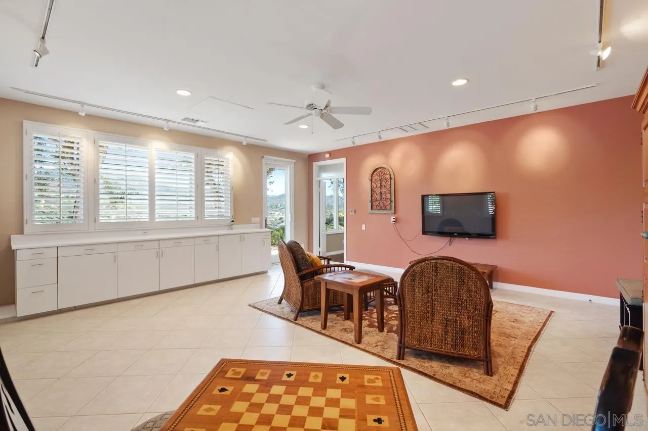 17065 Butterfield Trail Poway, CA 92064 - Photo 30 of 71 a living room with furniture a flat screen tv and floor to ceiling window