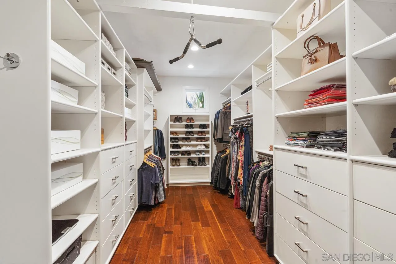 17065 Butterfield Trail Poway, CA 92064 - Photo 42 of 71 a view of walk in closet with clothes and shoes