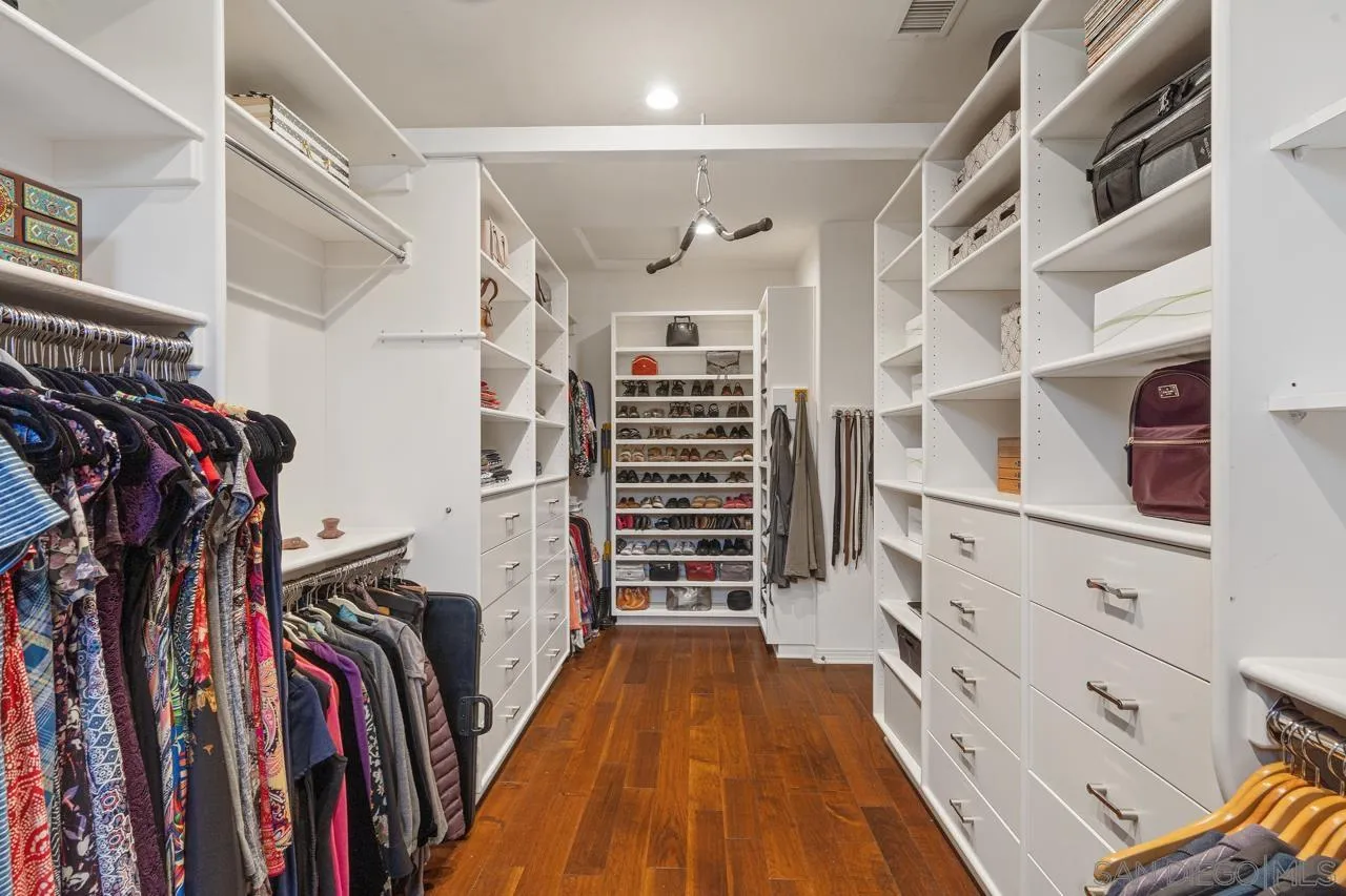 17065 Butterfield Trail Poway, CA 92064 - Photo 43 of 71 a view of walk in closet with clothes and shoes