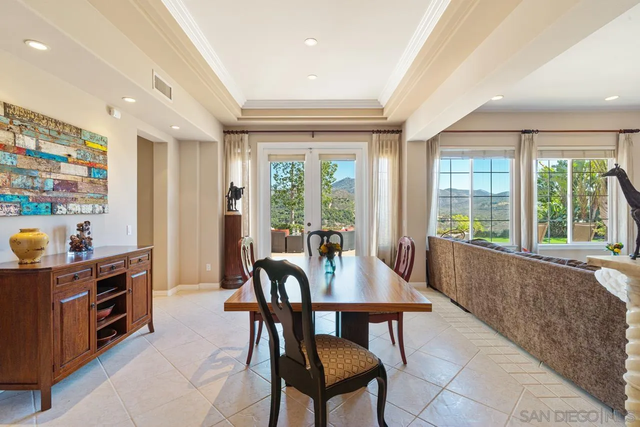 17065 Butterfield Trail Poway, CA 92064 - Photo 10 of 71 a view of a dining room with furniture large windows and wooden floor