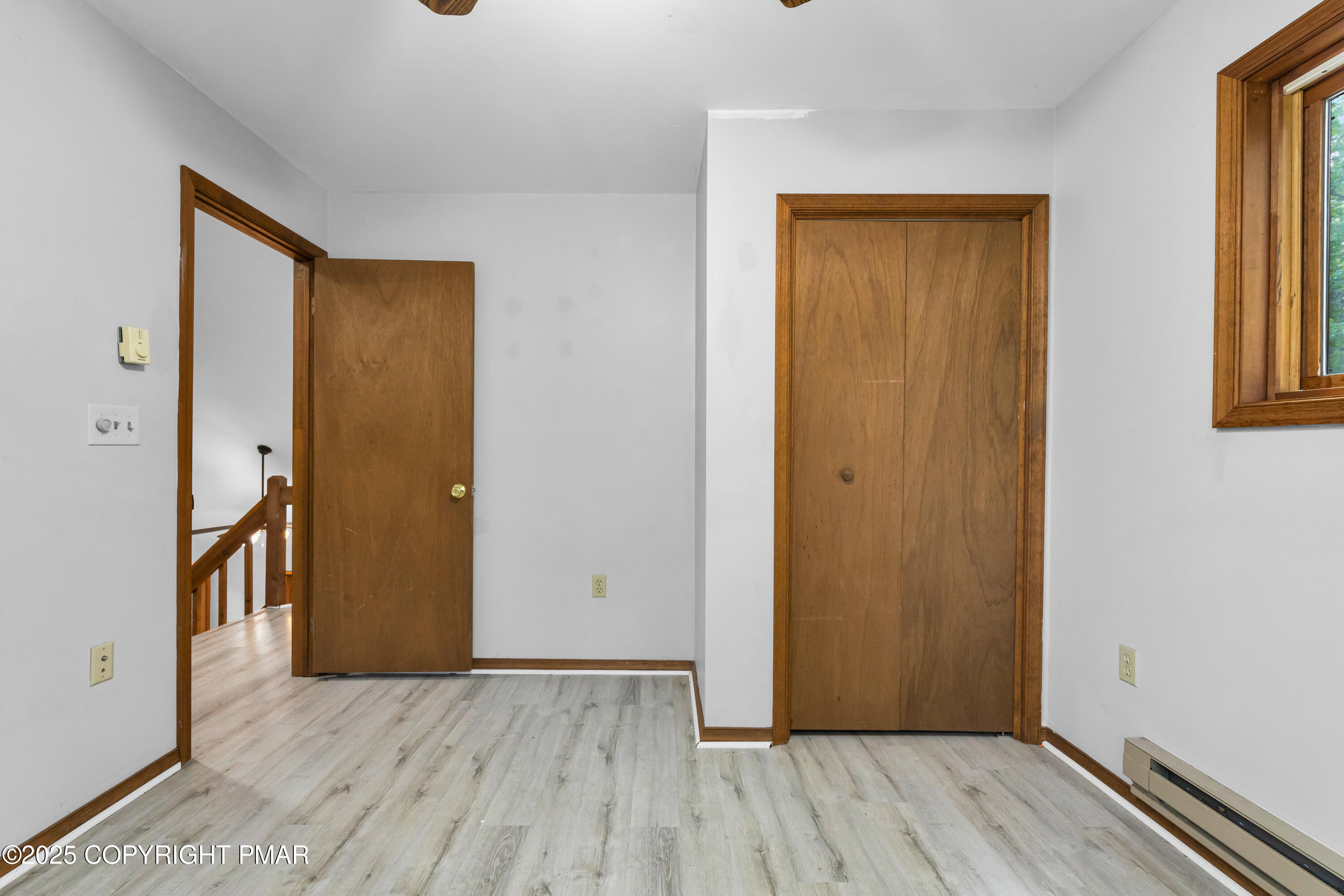 106 Carnforth Drive Bushkill, PA 18324 - Photo 27 of 73 an empty room with wooden floor and a window