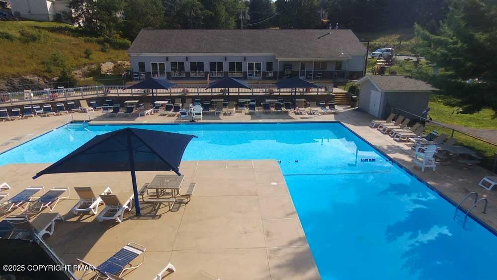 106 Carnforth Drive Bushkill, PA 18324 - Photo 51 of 73 a view of a house with swimming pool and sitting area
