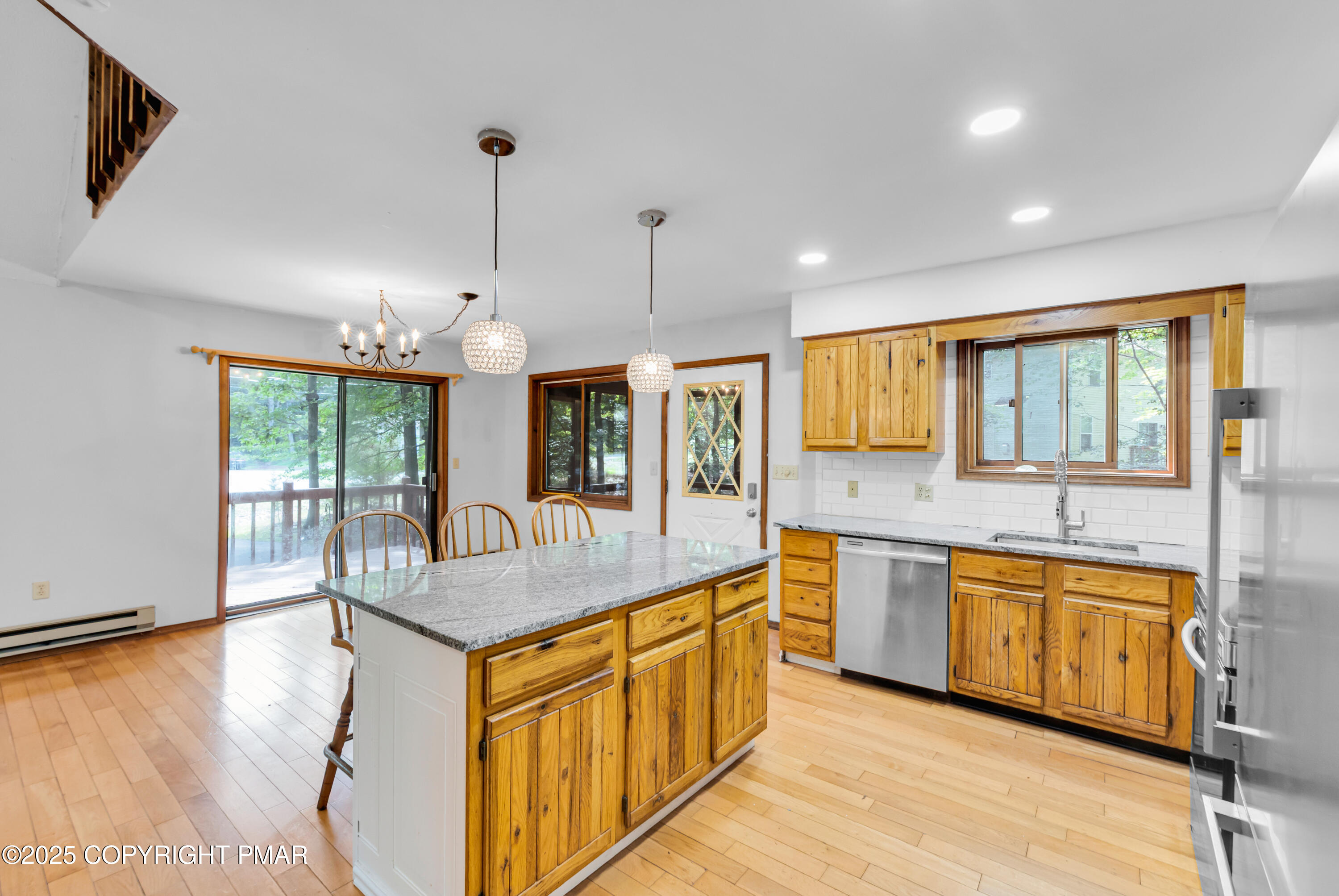 106 Carnforth Drive Bushkill, PA 18324 - Photo 9 of 73 a large kitchen with kitchen island granite countertop a large window a sink and stainless steel appliances