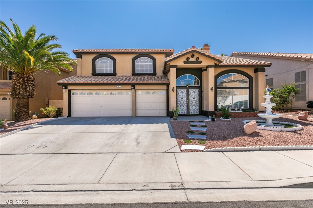 6 High Sierra Henderson, NV 89074 - Photo 1 of 56 Mediterranean / spanish-style home with stucco siding, driveway, a tile roof, an attached garage, and a chimney