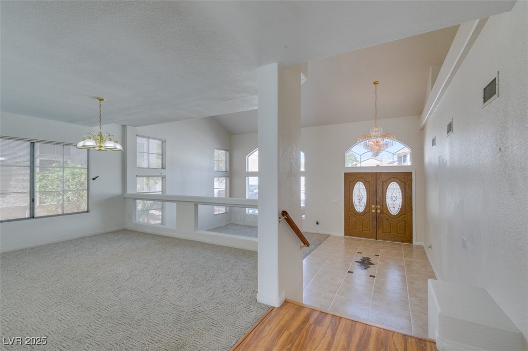 6 High Sierra Henderson, NV 89074 - Photo 12 of 56 Entrance foyer featuring a chandelier, baseboards, and lofted ceiling