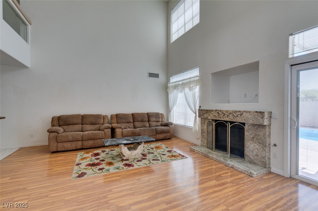 6 High Sierra Henderson, NV 89074 - Photo 19 of 56 Living area with a high ceiling, wood finished floors, a premium fireplace, and baseboards