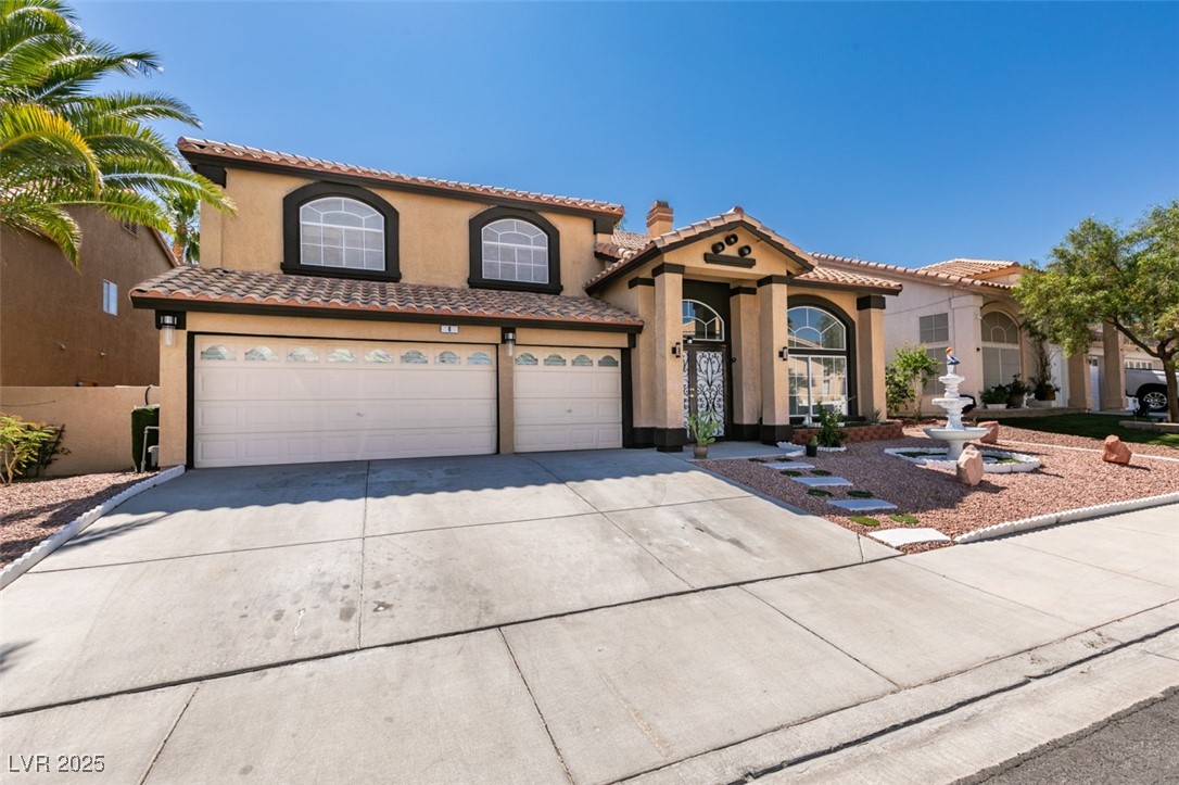 6 High Sierra Henderson, NV 89074 - Photo 2 of 56 Mediterranean / spanish home with concrete driveway, stucco siding, a tiled roof, and an attached garage