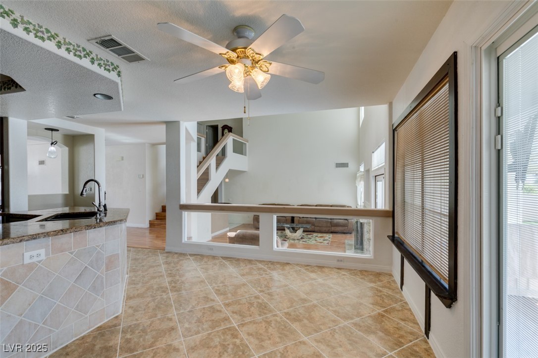 6 High Sierra Henderson, NV 89074 - Photo 31 of 56 Kitchen featuring a sink, stone countertops, ceiling fan, and light tile patterned floors