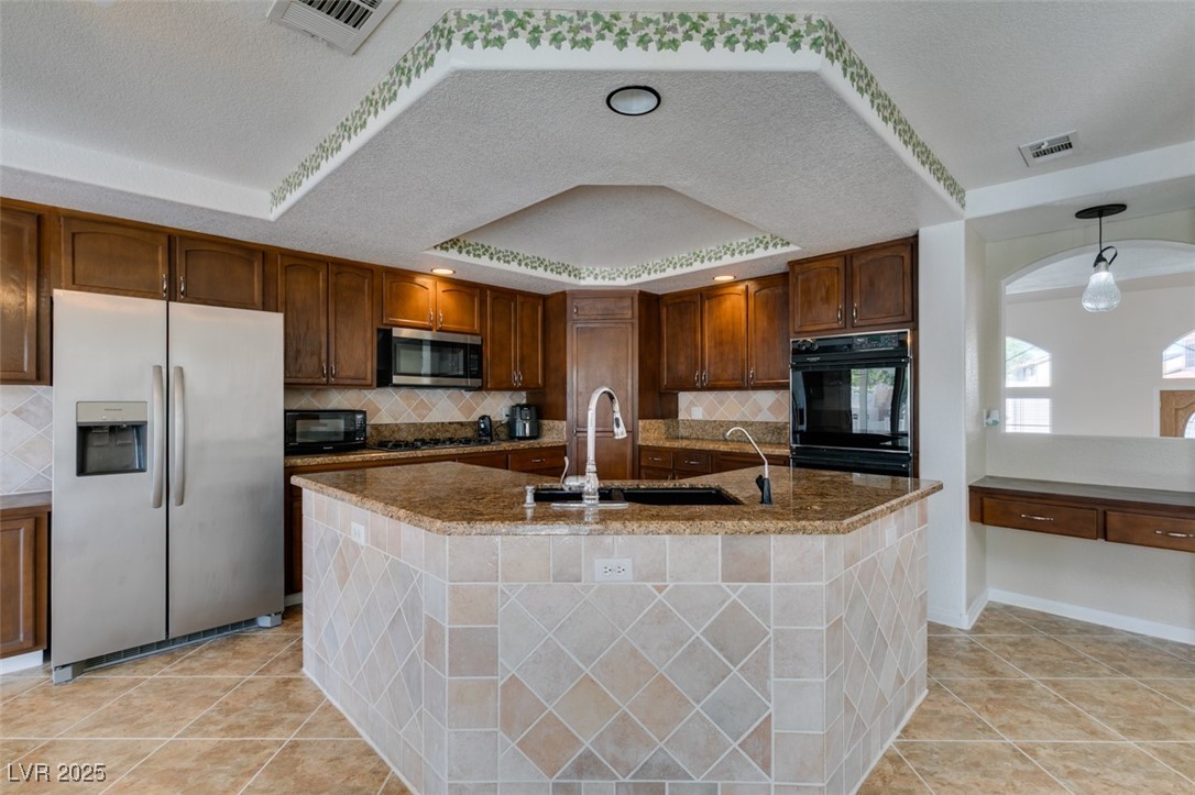 6 High Sierra Henderson, NV 89074 - Photo 34 of 56 Kitchen with black appliances, a sink, a textured ceiling, backsplash, and a raised ceiling