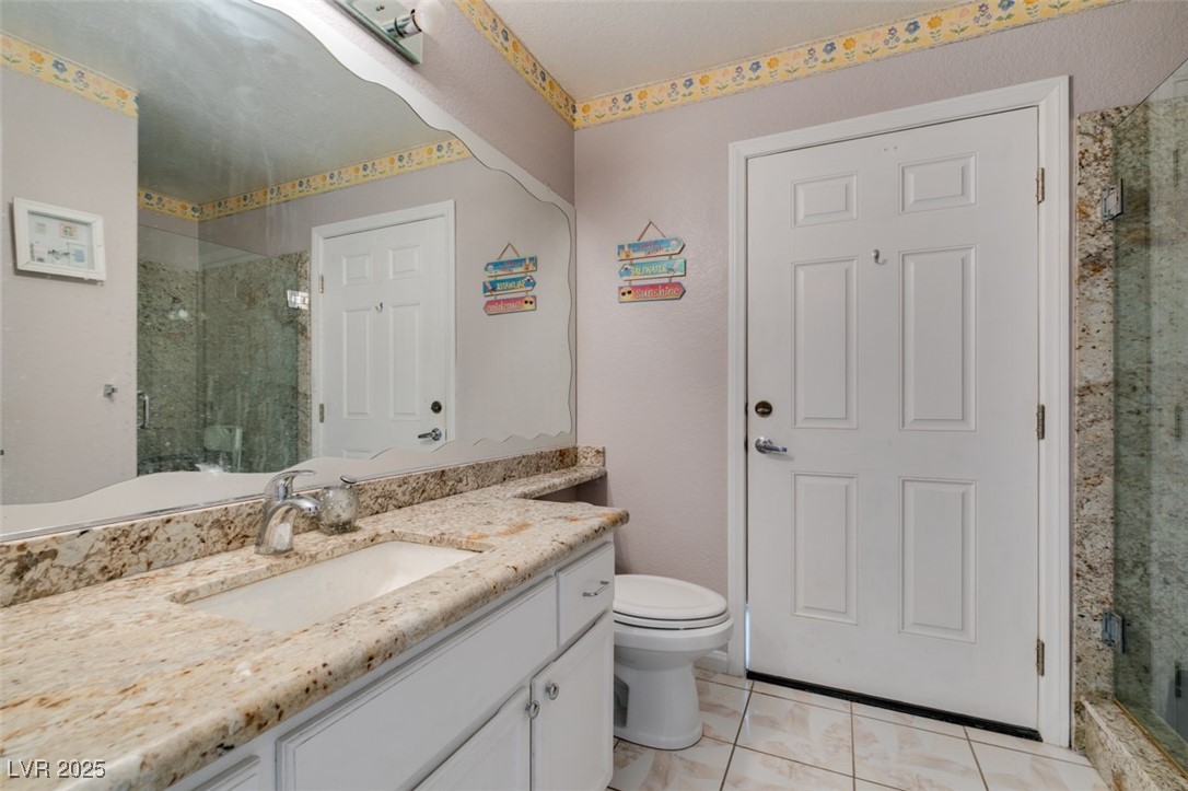 6 High Sierra Henderson, NV 89074 - Photo 38 of 56 Full bath featuring vanity, a stall shower, and toilet