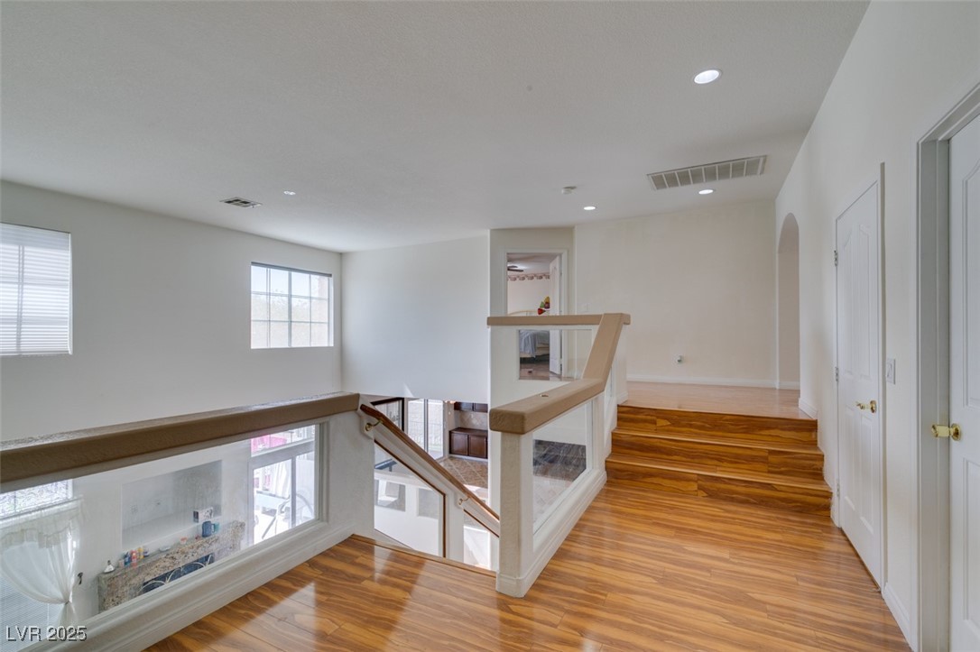 6 High Sierra Henderson, NV 89074 - Photo 39 of 56 Corridor featuring light wood-style floors, arched walkways, recessed lighting, an upstairs landing, and baseboards