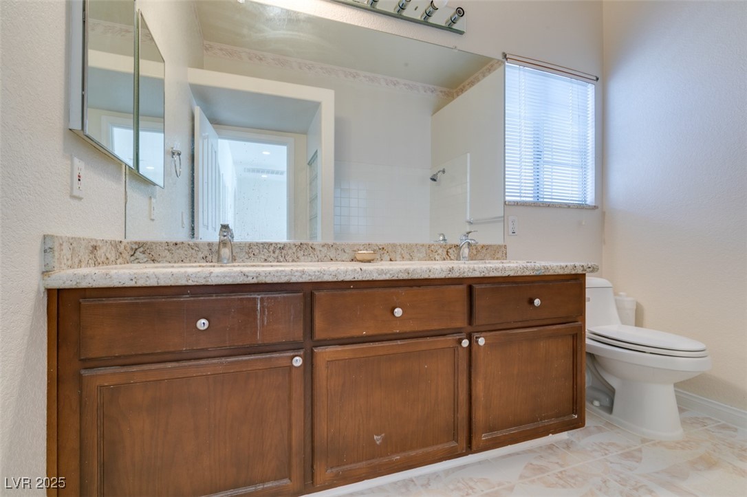 6 High Sierra Henderson, NV 89074 - Photo 41 of 56 Full bathroom featuring toilet, double vanity, and a shower