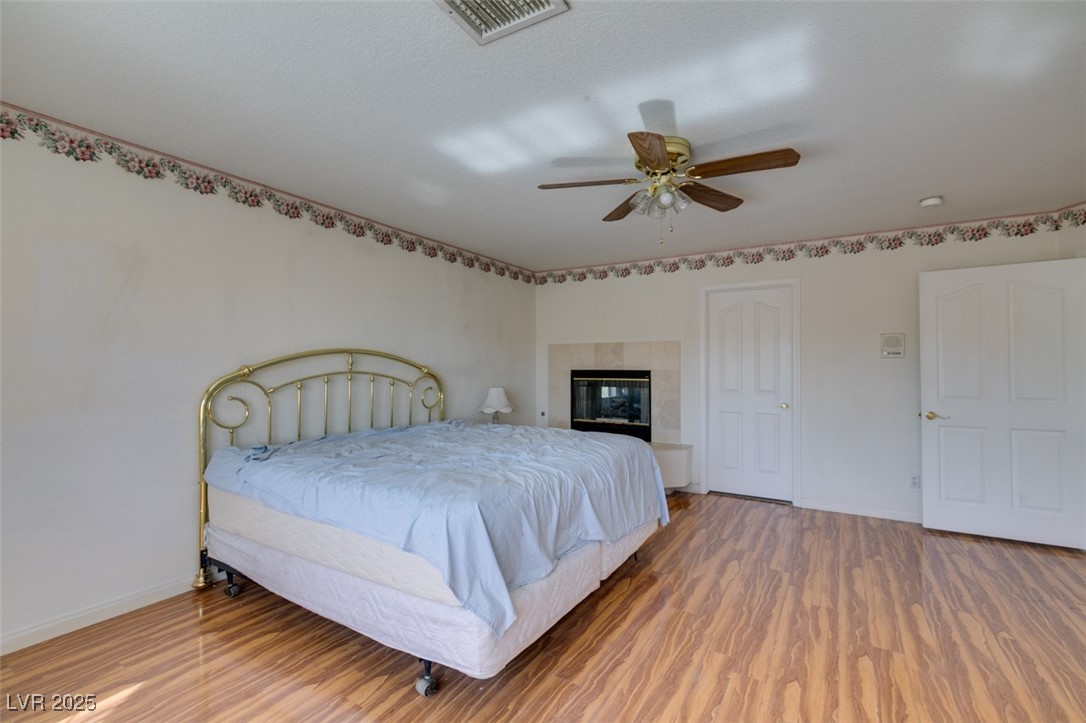 6 High Sierra Henderson, NV 89074 - Photo 45 of 56 Bedroom with wood finished floors, baseboards, and a ceiling fan