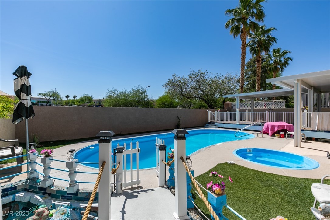 6 High Sierra Henderson, NV 89074 - Photo 50 of 56 View of swimming pool featuring a fenced backyard, a patio area, and an in-ground hot tub
