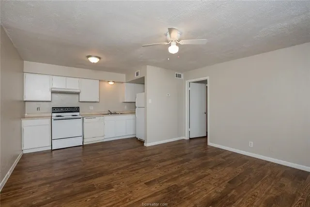a view of kitchen with wooden floor and electronic appliances