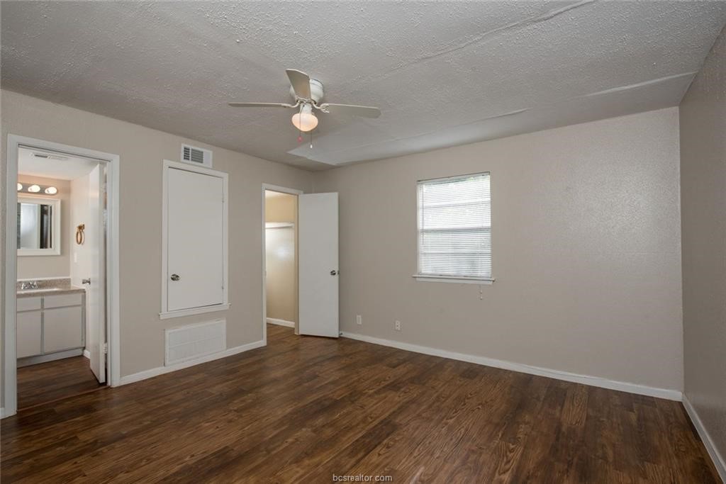 3900 Old College Road, Unit 33 Bryan, TX 77801 - Photo 7 of 10 an empty room with wooden floor and windows