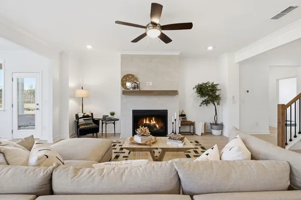 a view of a dining room with furniture a rug and wooden floor