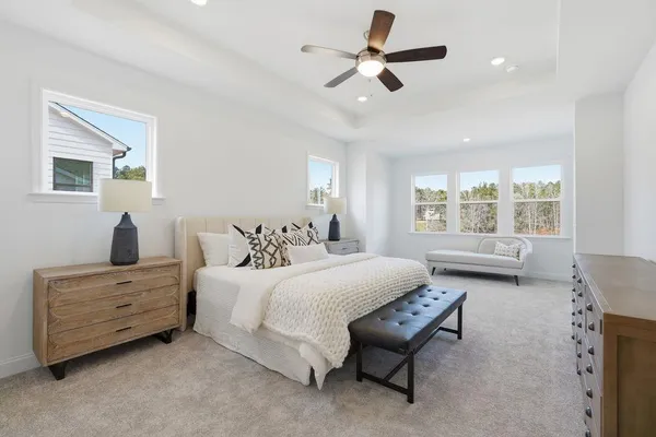 a bedroom with a bed table and window