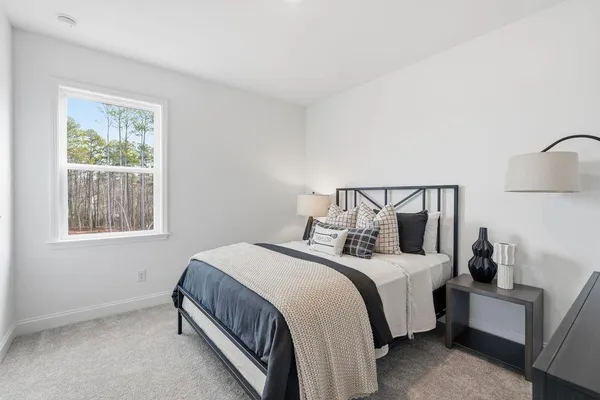 a bathroom with a toilet a sink a glass door a shower a mirror a vanity and window