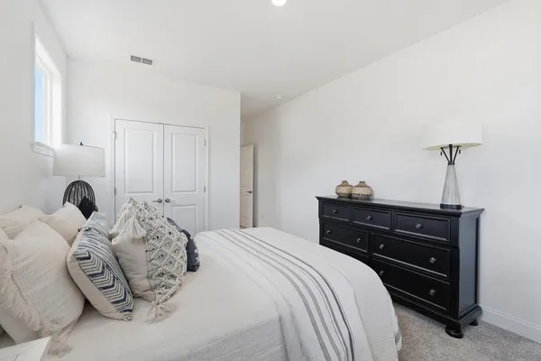 a en suite bathroom with a double vanity sink a mirror and a bathtub