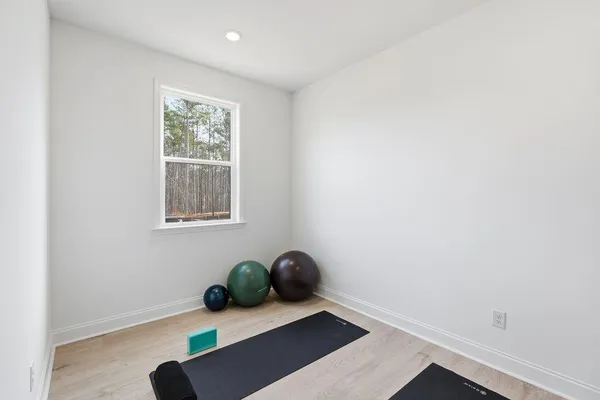 a view of a white house with a yard and furniture