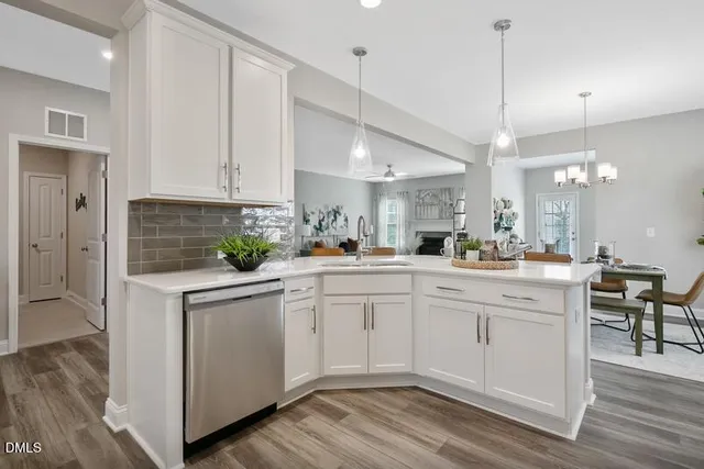 a kitchen with white cabinets and white appliances