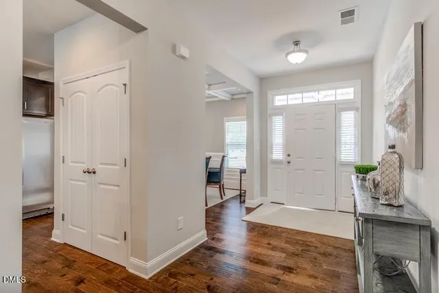 a living room with wooden floor and furniture