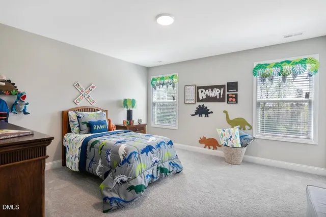 a bedroom with a bed a table and a window