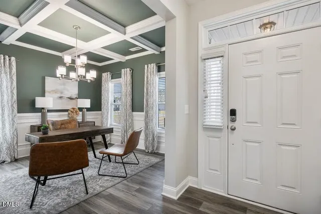a view of a room with furniture and wooden floor