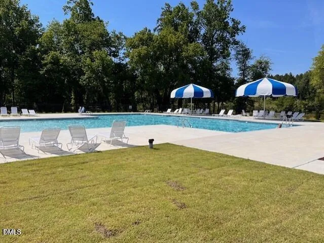 a view of a swimming pool and a yard
