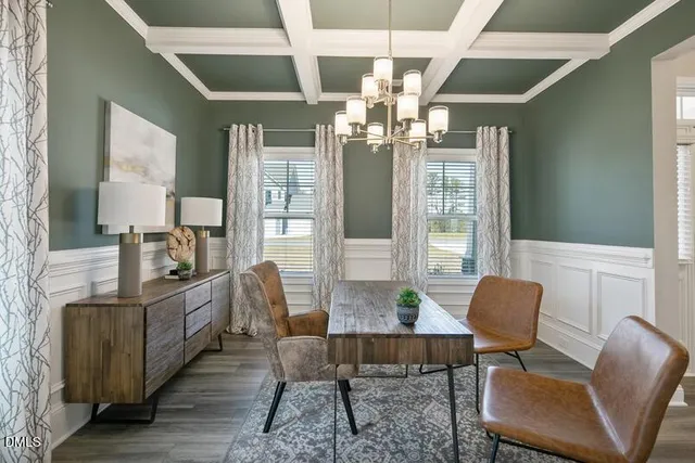 a view of a dining room with furniture and chandelier