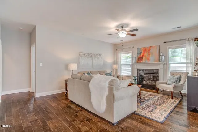 a living room with furniture fireplace and window