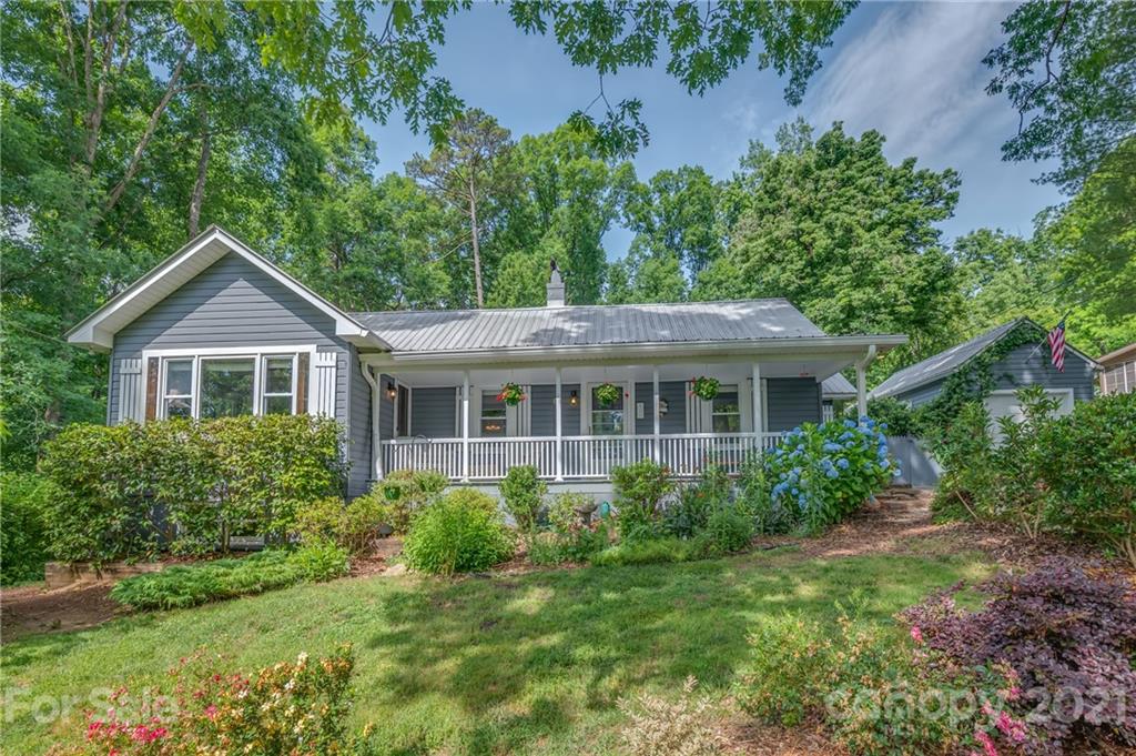 75 Hidden Hill Road Tryon, NC 28782 - Photo 1 of 36 a front view of a house with a yard