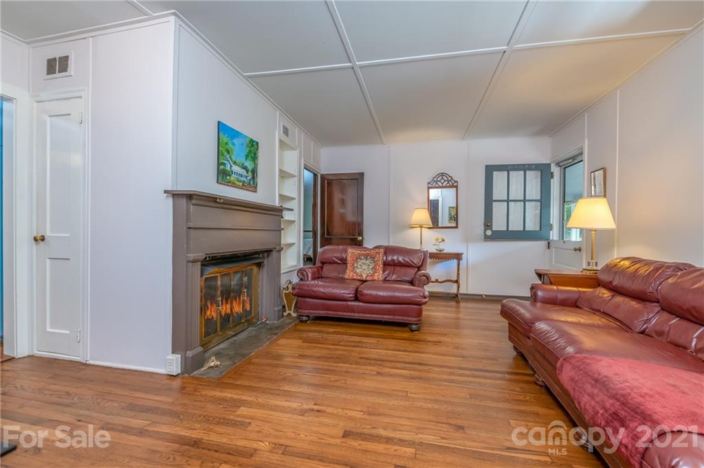 75 Hidden Hill Road Tryon, NC 28782 - Photo 13 of 36 a living room with furniture and a fireplace